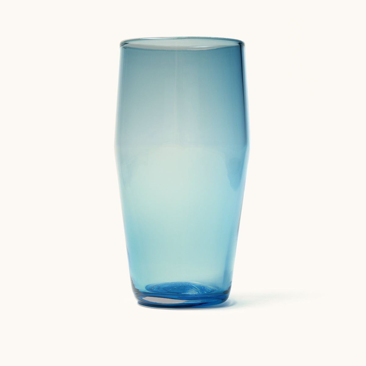 A semi-transparent light blue standard pint glass with a subtly tapered cylindrical form and a darker base.