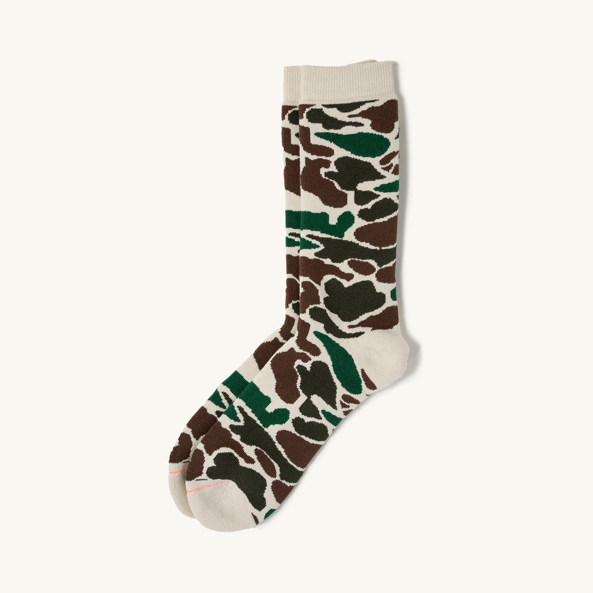 Ivory pile camo crew socks with brown and green pattern, ribbed cuff, and pink toe seam on white background.