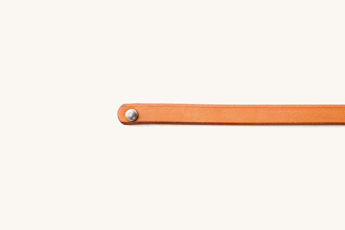 Saddle Tan Double Wrap Wristband featuring a silver rivet on its rounded leather end.