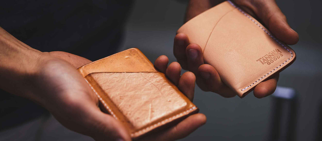 Hands holding two leather wallets, one worn, one new, showcasing craftsmanship and quality.