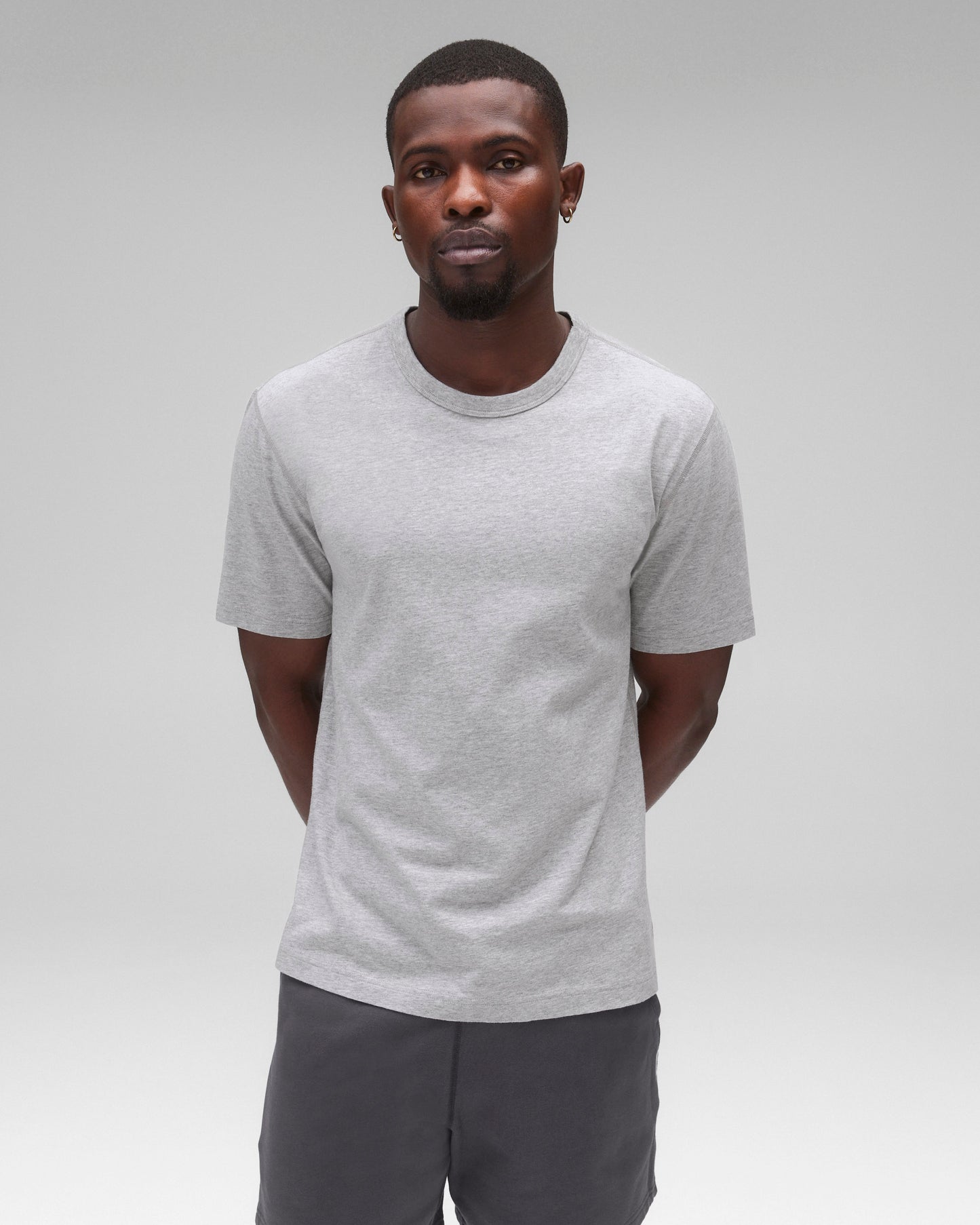 Lightweight grey jersey standard t-shirt, worn with dark grey shorts.