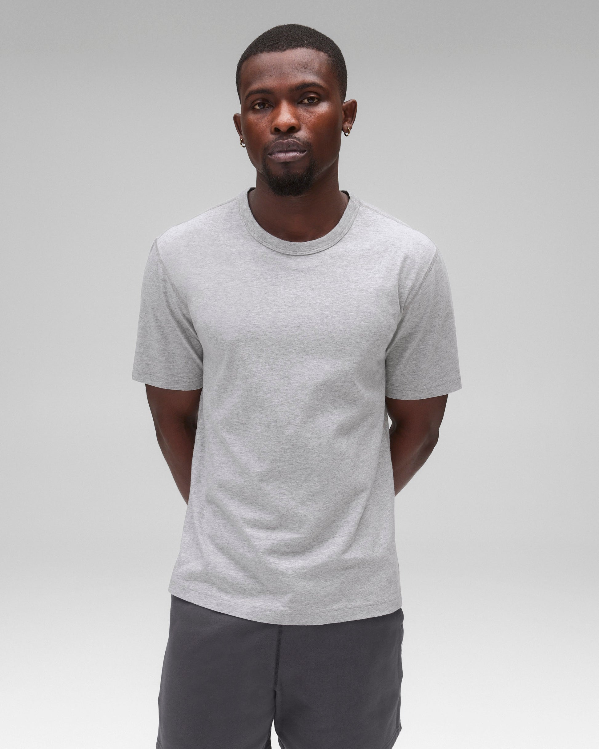 Lightweight grey jersey standard t-shirt, worn with dark grey shorts.