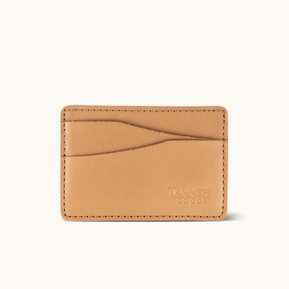 Light tan leather card wallet by Tanner Goods, featuring curved card slots and perimeter stitching.
