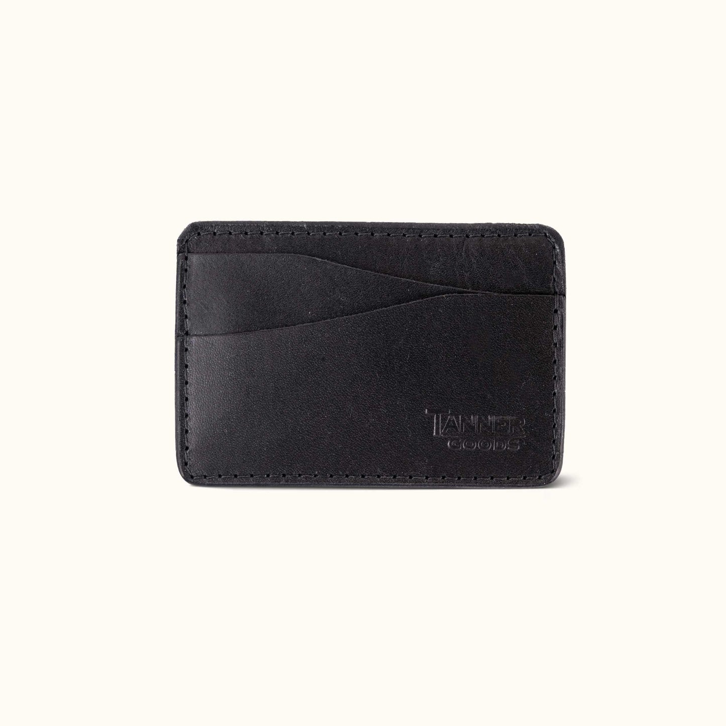 Black leather Money Clip Journeyman by Tanner Goods, with stitched edges, card slots, and a debossed logo.