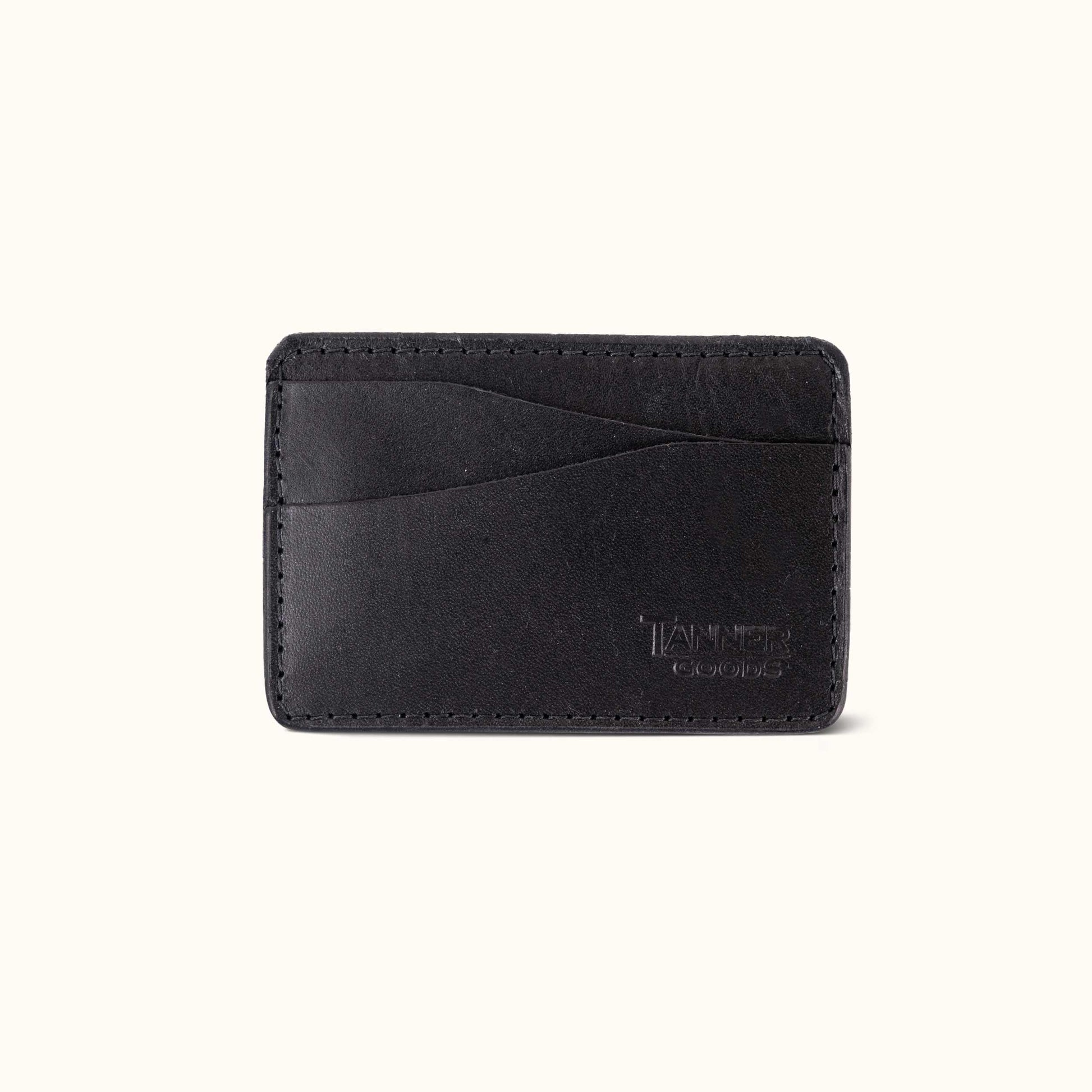 Black leather Money Clip Journeyman by Tanner Goods, with stitched edges, card slots, and a debossed logo.