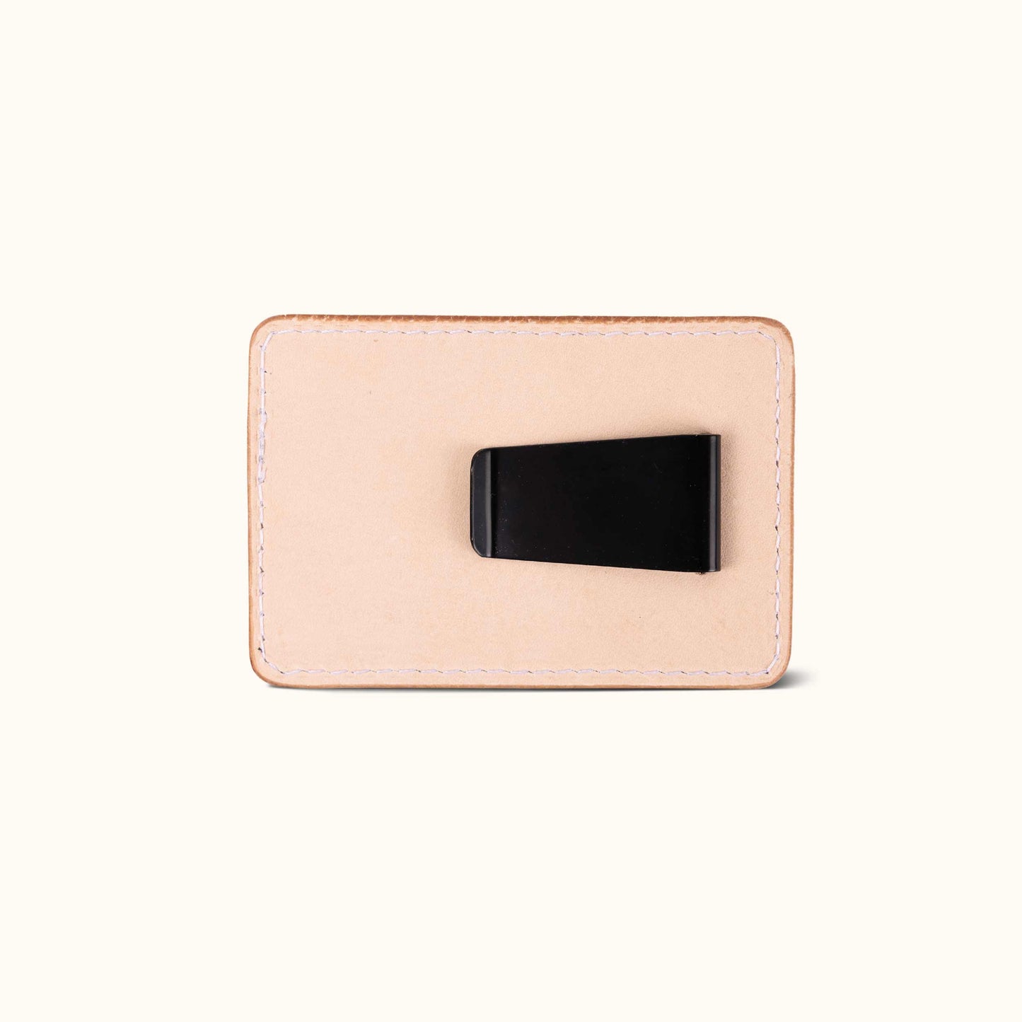 Natural leather money clip, rectangular with white stitching and a black metal clip on the back.