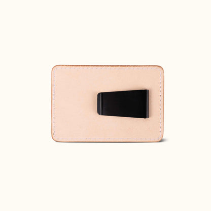 Natural leather money clip, rectangular with white stitching and a black metal clip on the back.
