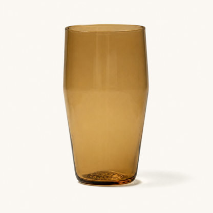Amber tinted standard pint glass with textured base, front view, clear glass material, smooth finish