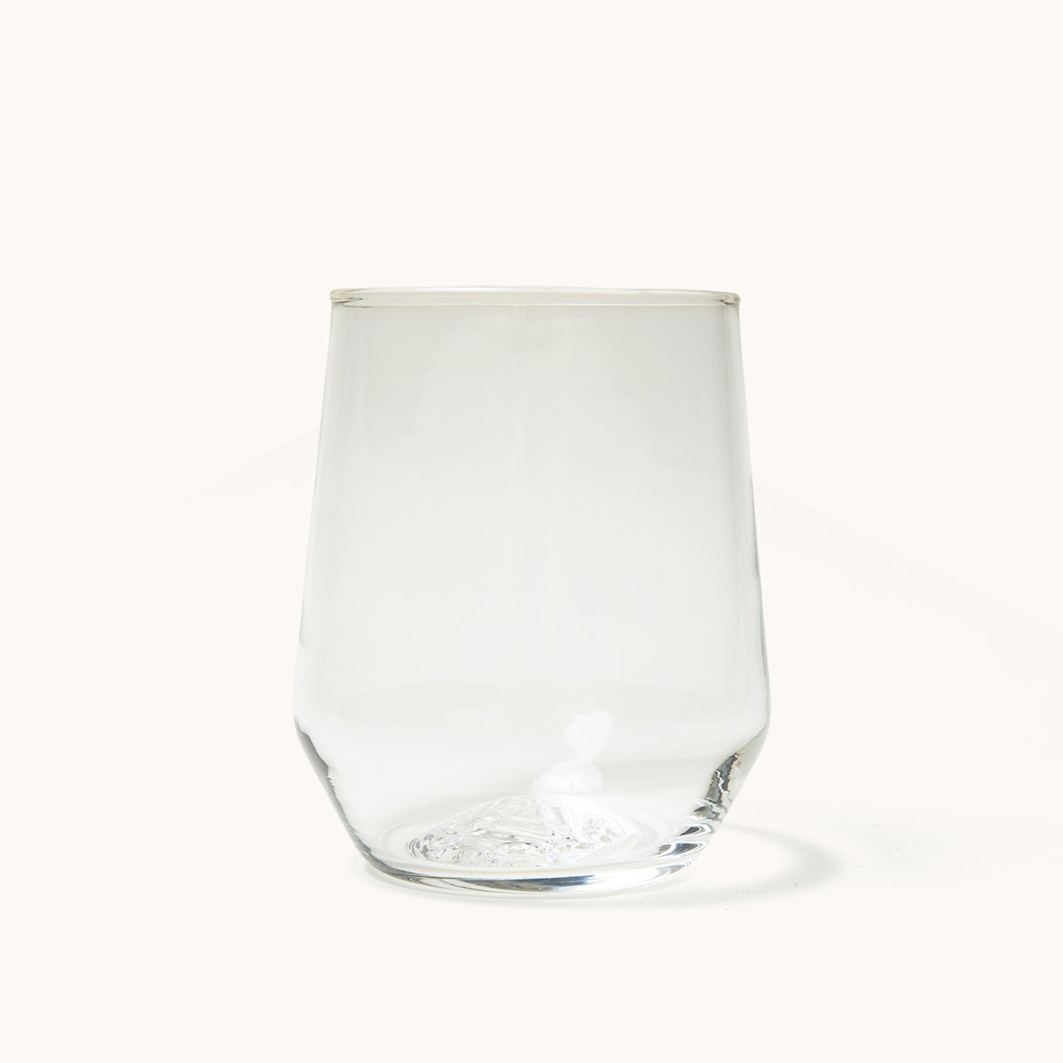 Clear stemless wine glass with textured base, front view on white background