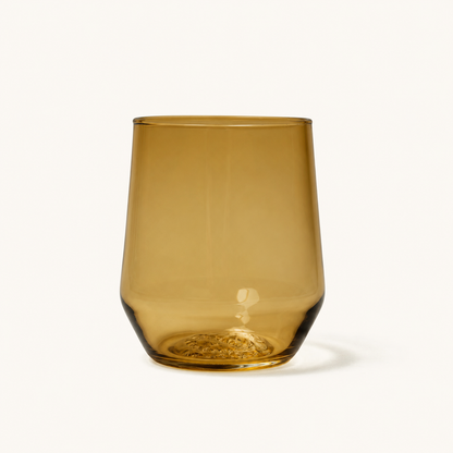 Amber-colored stemless wine glass with textured base, front view, smooth glass finish