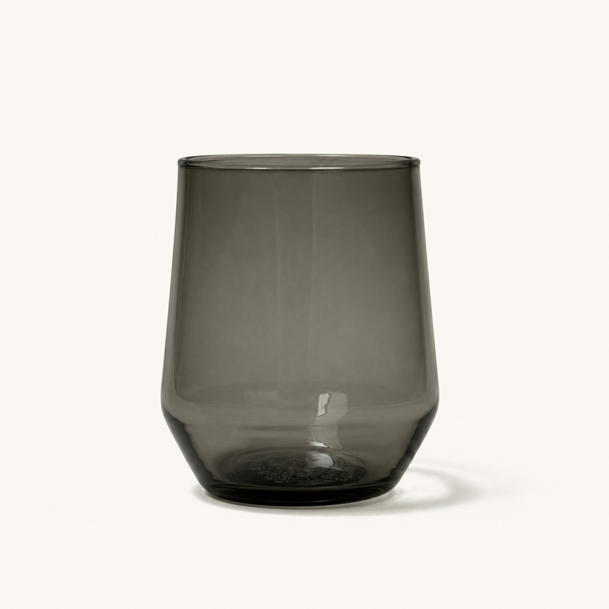 Smoky gray stemless wine glass with textured base, front view, clear glass material, minimalist design