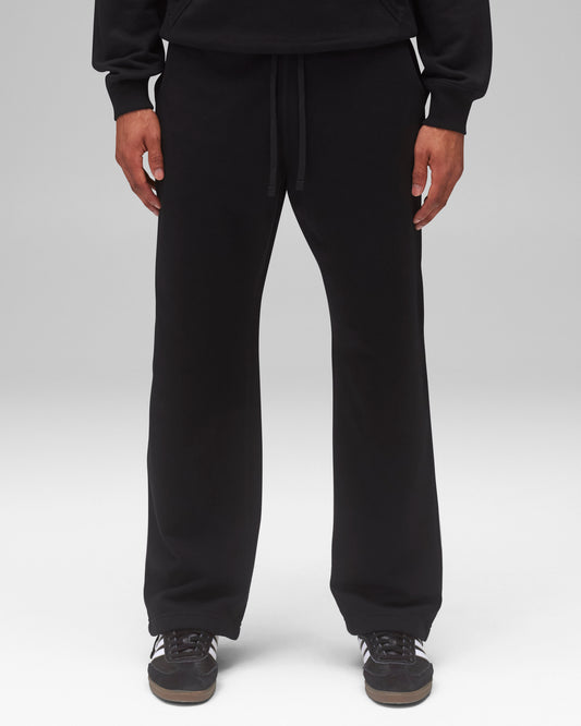 Black Midweight Terry Relaxed Sweatpants with a drawstring, worn with a black hoodie and sneakers.