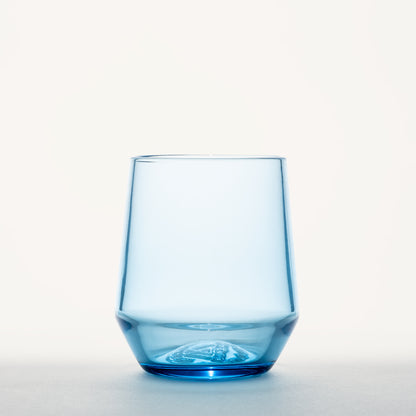 Blue stemless wine glass with a thick, faceted base and an embossed design on the bottom.