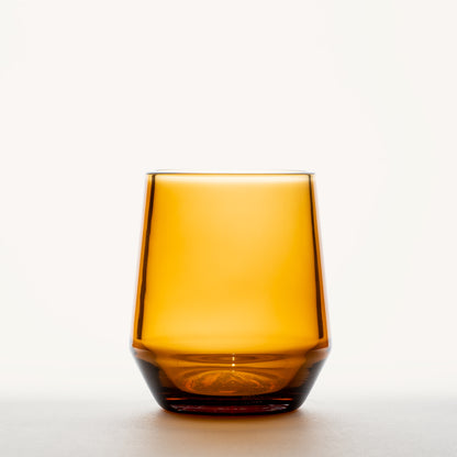 Amber wine glass with a thick base and stemless design, shown against a plain white background.