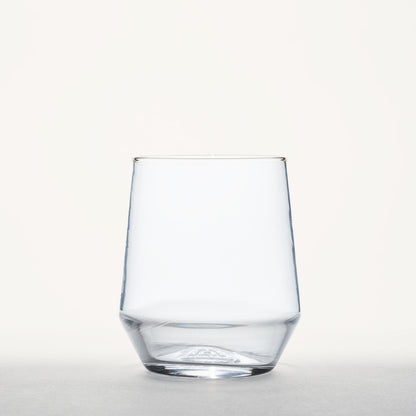 Clear stemless wine glass with a thick, faceted base and tapered sides, shown front-facing on a neutral background.