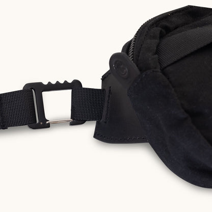 Black waxed canvas crossbody mini with black webbing strap and black clip featuring a silver bar.