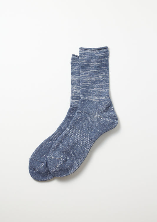 Pair of slate blue Washi Pile crew socks with a heathered, speckled texture and ribbed cuff, lying flat.
