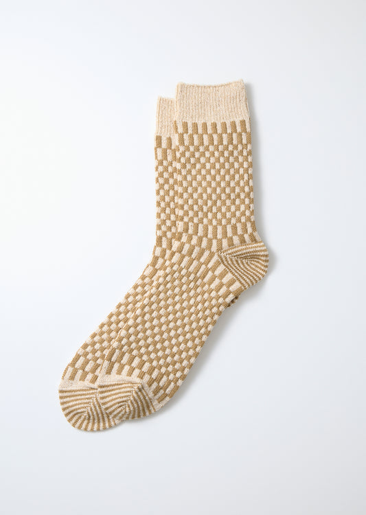 Beige and cream checkerboard pattern socks, knitted with ribbed cuffs and striped heel and toe.