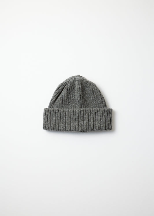 Dark gray recycled wool beanie with a ribbed folded brim and knitted texture, flat lay on white.