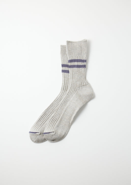 Pair of light gray hemp organic cotton socks with purple stripes on the ribbed cuffs and reinforced toes.