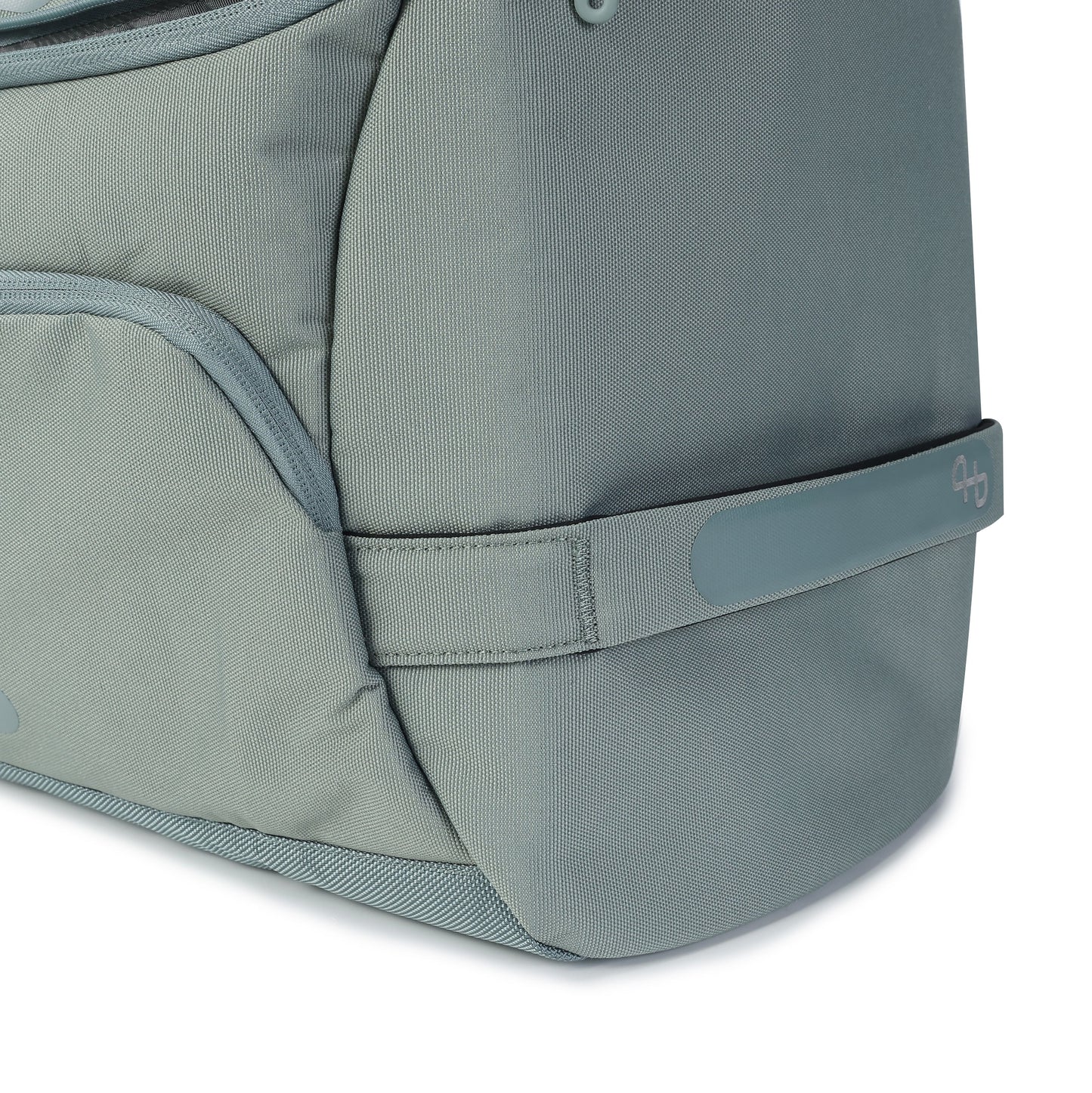 Sage green duffle bag by Hedgren, with woven texture, rounded corner, and side strap featuring a debossed logo.