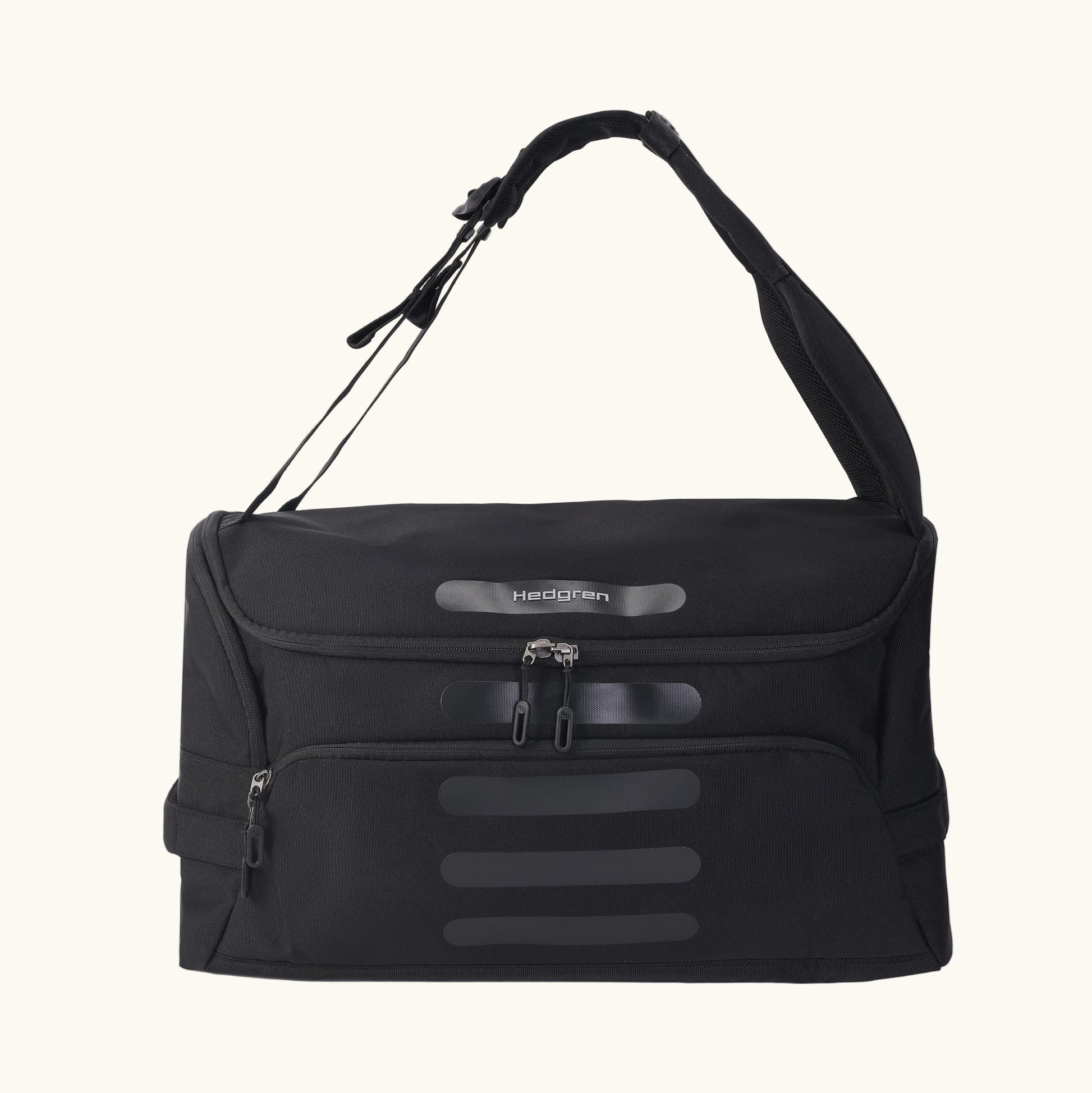 A green Hedgren Sojourn duffle bag with multiple compartments and a rolled-up design, featuring a shoulder strap and a top handle.