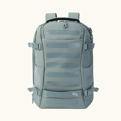 Sage green woven fabric backpack by Hedgren featuring horizontal front bands and side compression buckles, front view.