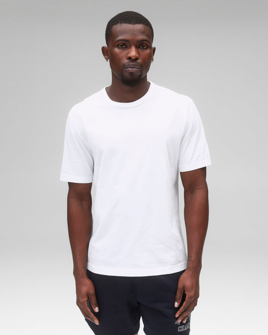 White lightweight jersey t-shirt with a crew neck and short sleeves, worn by a male model with dark shorts.