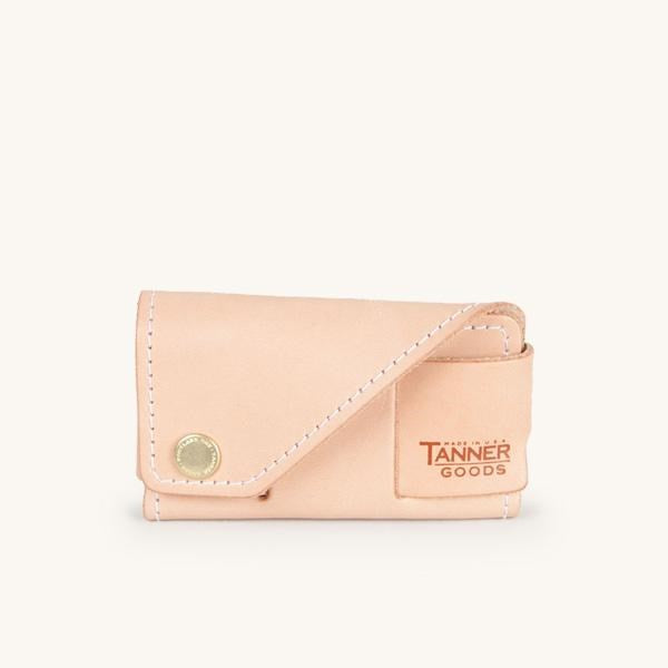 Natural leather cardholder by Tanner Goods featuring white stitching and a brass snap.