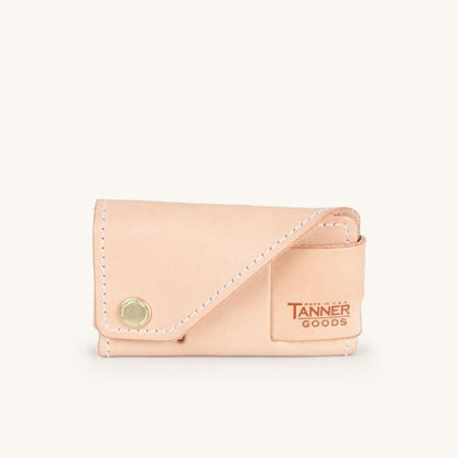 Natural leather cardholder by Tanner Goods featuring white stitching and a brass snap.