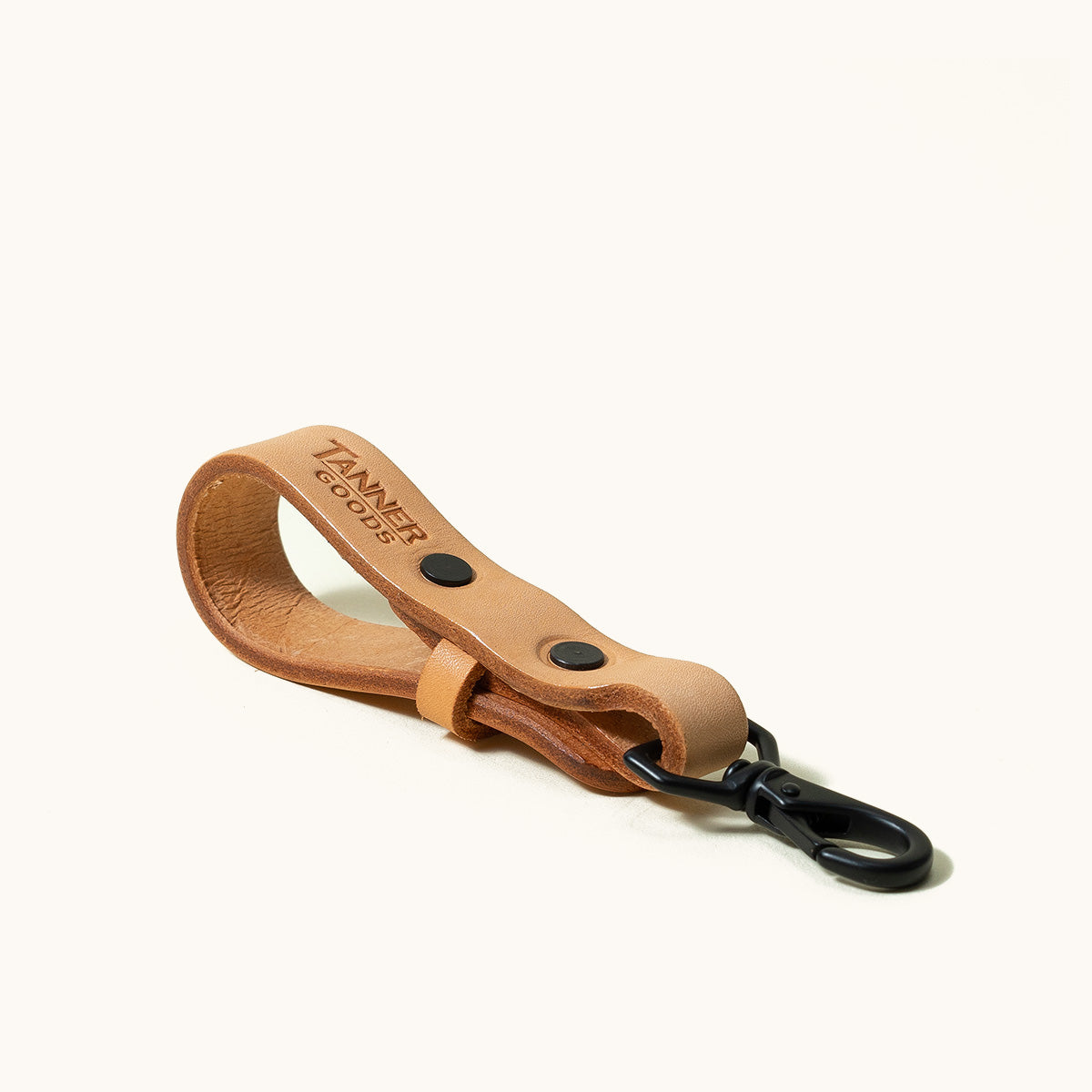Natural leather Key Lanyard with imprinted 'TANNER GOODS' logo and black metal swivel clip, against a white background.