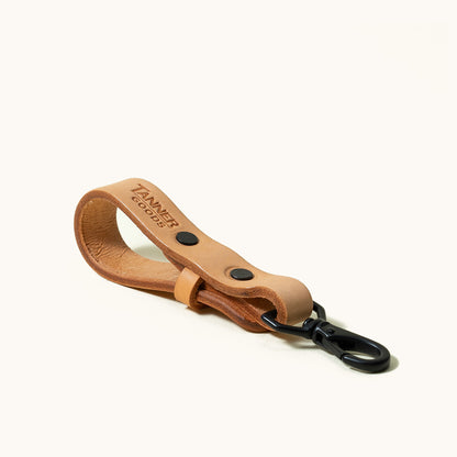 Natural leather Key Lanyard with imprinted 'TANNER GOODS' logo and black metal swivel clip, against a white background.