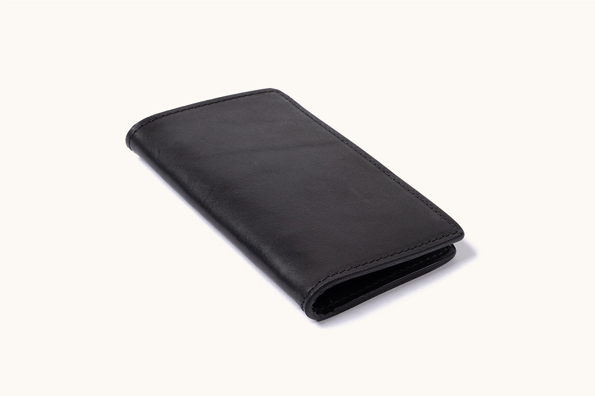 Black bifold wallet with smooth texture and visible stitching, angled and slightly open.