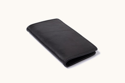 Black bifold wallet with smooth texture and visible stitching, angled and slightly open.