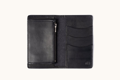 Black leather bifold wallet, open to reveal three card slots, a zippered pocket, and an embossed logo.
