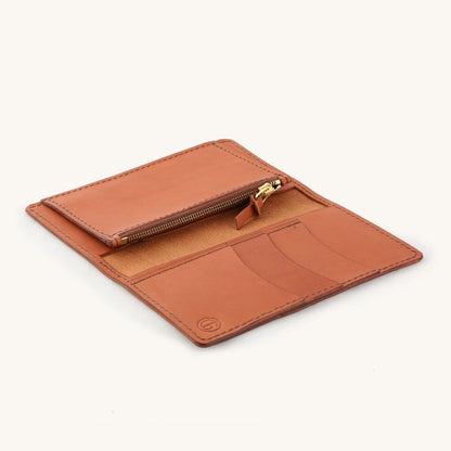 Chestnut leather bifold wallet, open to reveal a zippered coin pouch, multiple card slots, and dark stitching.