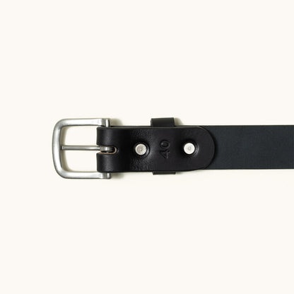 Classic black leather belt with a silver buckle, stamped '40', and two visible rivets, flat lay.