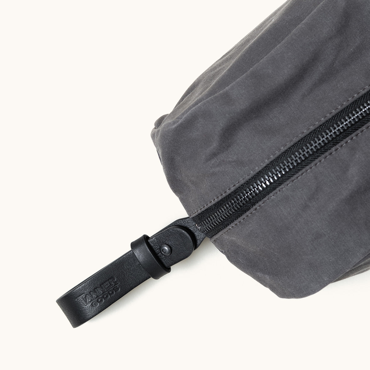 Slate Grey waxed canvas Dopp Kit by TANNER GOODS, featuring a black zipper and embossed leather pull tab.