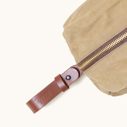 Utility Tan waxed canvas Dopp Kit by Tanner Goods with a brown leather zipper pull and gold zipper teeth.