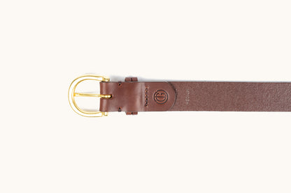 Cognac leather belt with a gold-toned buckle, embossed logo, and "MEDIUM" text, laid flat.