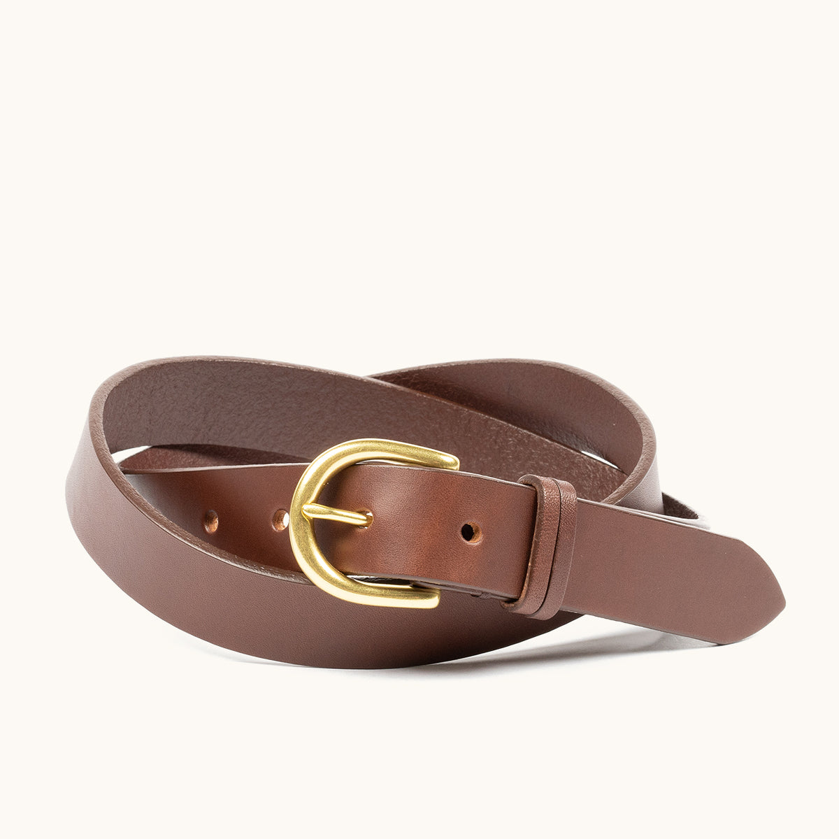 Cognac brown leather belt with a gold-tone buckle, coiled on a white background.