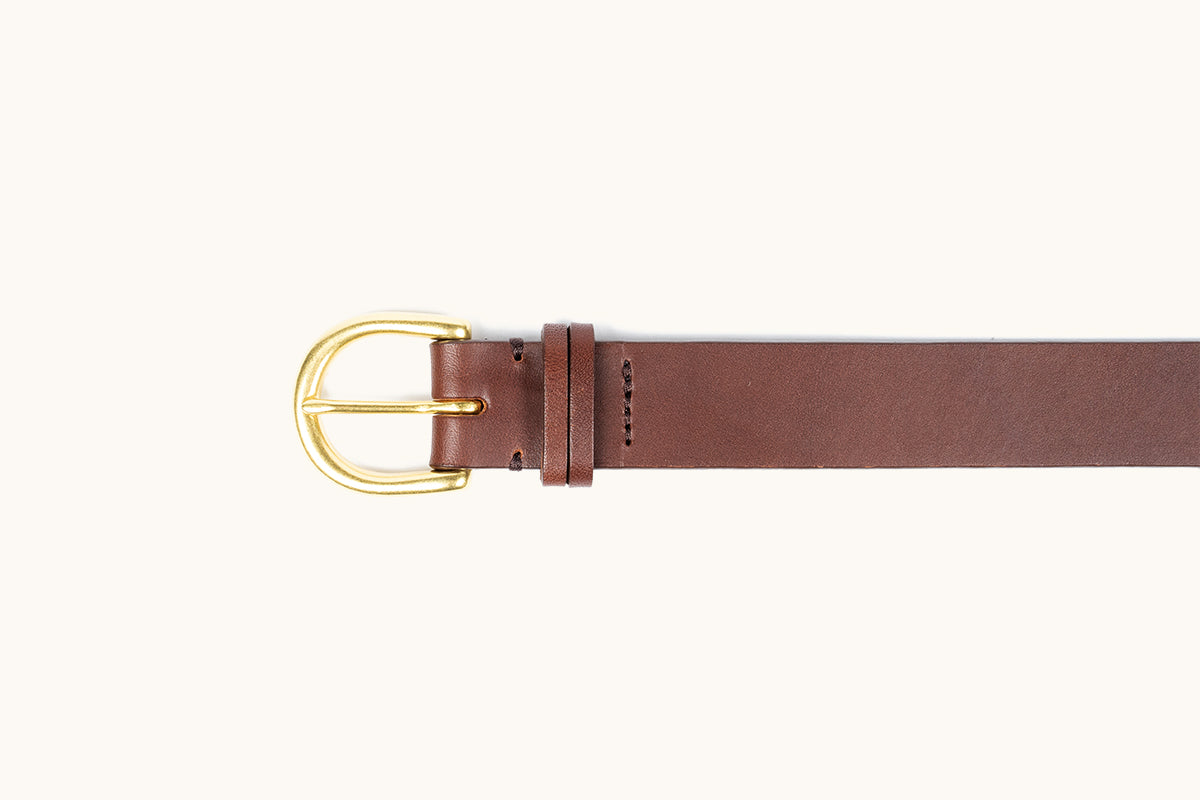 Cognac brown leather belt with a gold-tone D-shaped buckle and stitched details.