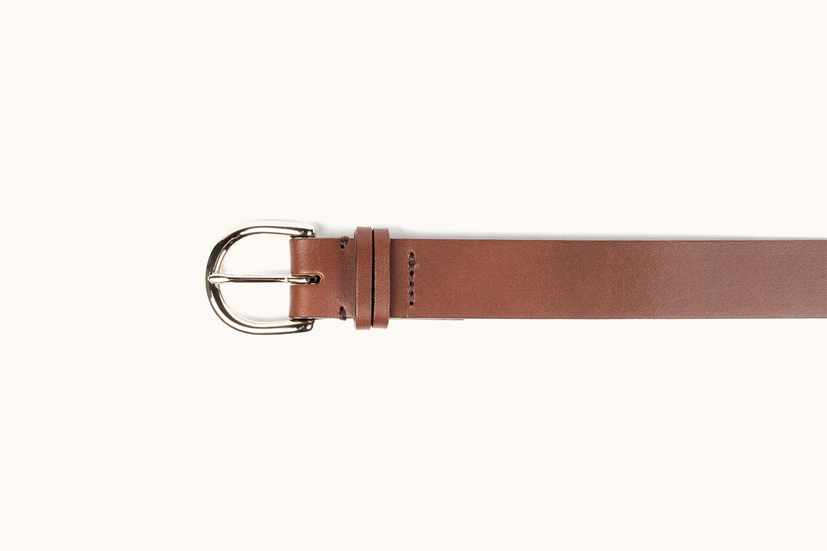 Cognac leather Meridian belt with a polished silver-tone rounded buckle, single prong, visible stitching, and a keeper loop.