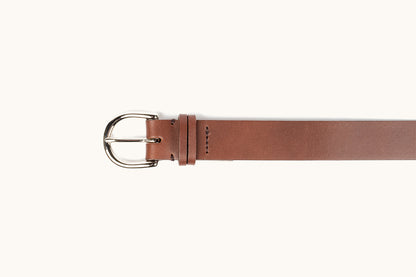 Cognac leather Meridian belt with a polished silver-tone rounded buckle, single prong, visible stitching, and a keeper loop.