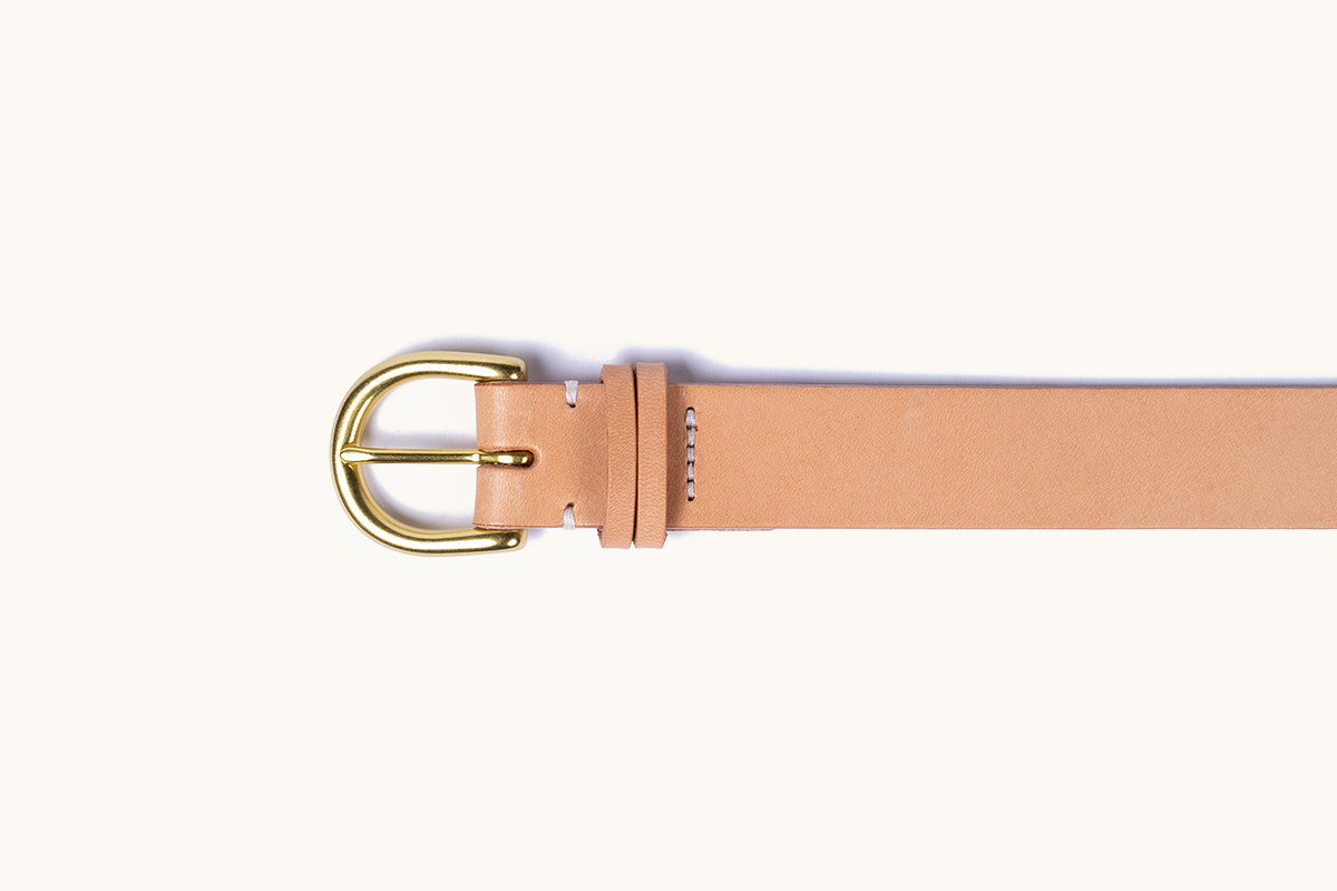 Natural leather belt with a polished gold-tone buckle and visible white stitching.