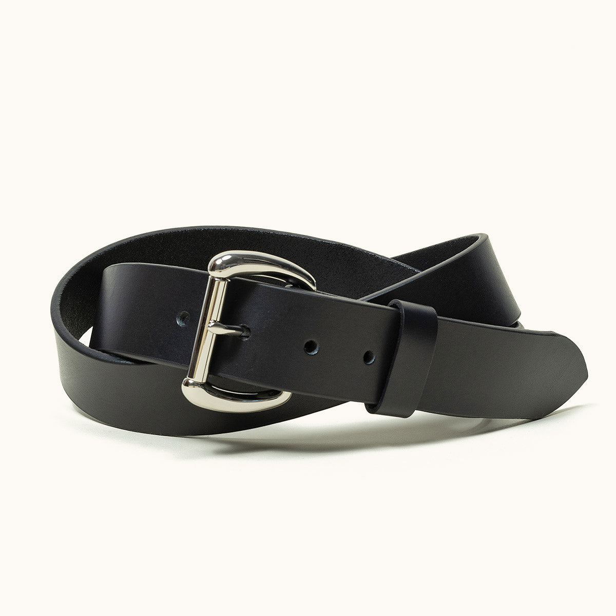 A coiled black belt with a stainless roller bar belt buckle.