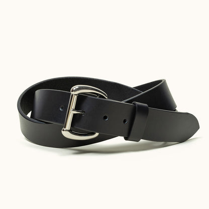 A coiled black belt with a stainless roller bar belt buckle.