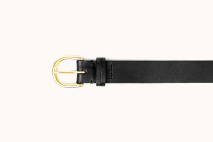 Black leather belt with a rounded gold-toned buckle and a single keeper loop, flat lay.