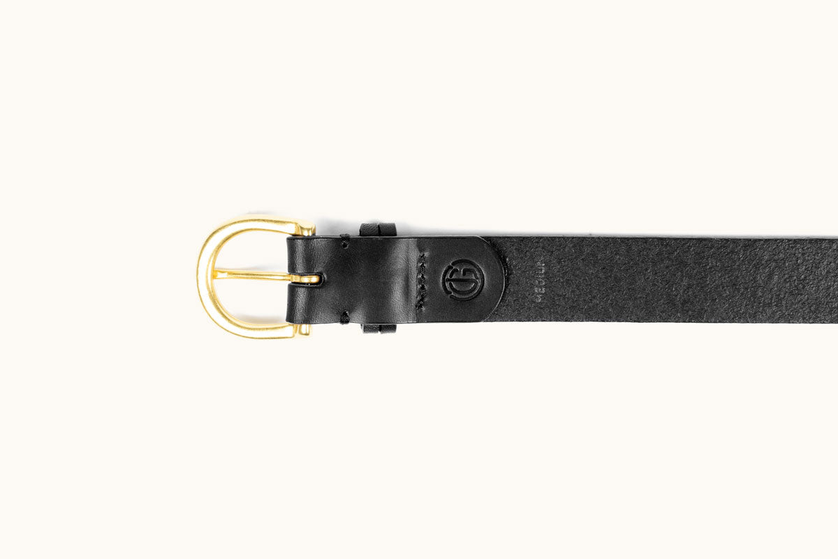 A black leather belt with a gold buckle, embossed circular logo, and "MERIDIAN" text.