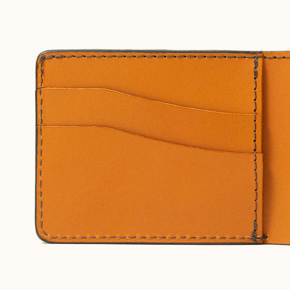 Saddle Tan Utility Bifold wallet interior with three leather card slots and visible stitching.